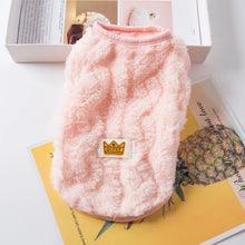 pink sweater on top of magazines