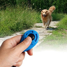 hand holding a blue dog whistle with dog on te backgrund