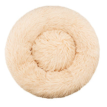 Beige round fluffy donut dog bed with a soft plush surface, raised outer edge and cushioned centre