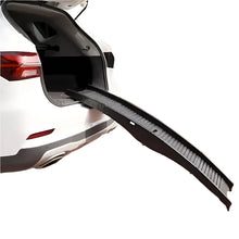 Black foldable dog ramp with a ridged non-slip surface positioned at the open boot of an SUV