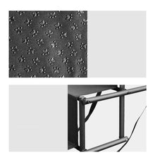Close-up of black foldable pet stairs showing paw-print non-slip fabric and the metal support frame