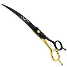 Black and gold curved dog grooming scissors with ergonomic finger rings for precision pet trimming