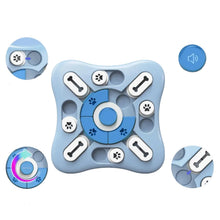 Blue interactive dog puzzle toy with sliding treat compartments, central button and sound feature