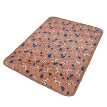 Brown quilted waterproof pet mat with a playful dog print and blue shapes, suitable for pet beds, crates or resting areas
