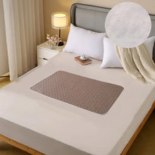 Small brown quilted waterproof mattress protector pad with rounded edges placed on a bed