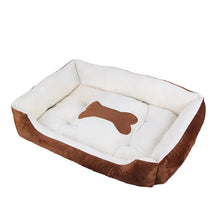 Brown and white cushioned dog bed with raised sides, a padded base and a bone-shaped centre detail