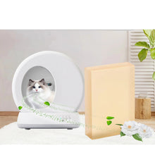 Cat litter box odour eliminator sheet beside a self-cleaning litter box with a cat, shown with fresh scent imagery