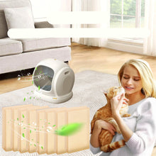 Cat litter box odour eliminator sheets shown beside an automatic litter box, with a woman holding her cat in a clean home setting