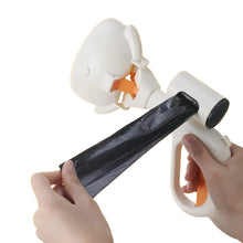 Portable dog poop scooper with built-in waste bag dispenser shown with a black waste bag being pulled from the handle