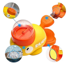Duck-shaped interactive dog food dispenser with clear kibble chamber, paw-operated paddles and removable components