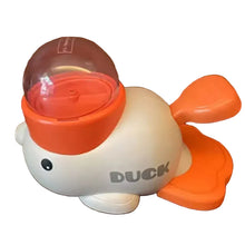 Duck-shaped interactive dog treat dispenser toy with clear food container and orange feeding paddles