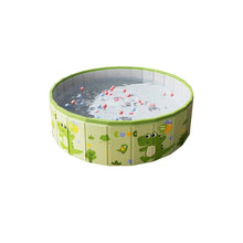 Green round foldable kids pool with crocodile print, filled with water and colourful floating balls