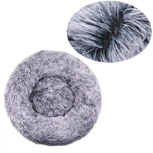 Grey fluffy donut dog bed with a soft faux fur surface, raised outer edge and close-up detail of the long plush fibres