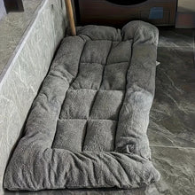 Grey plush dog bed with raised cushioned sides and a quilted padded centre for comfortable resting