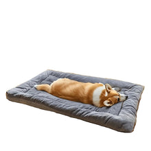 Corgi sleeping on a soft grey plush dog bed with raised cushioned edges