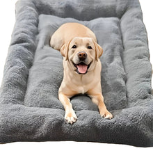 Labrador puppy relaxing on a soft grey plush dog bed with raised cushioned sides