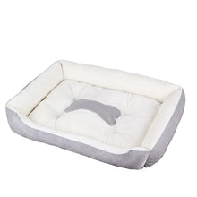 Grey and white cushioned dog bed with raised sides, padded base and a bone-shaped centre detail