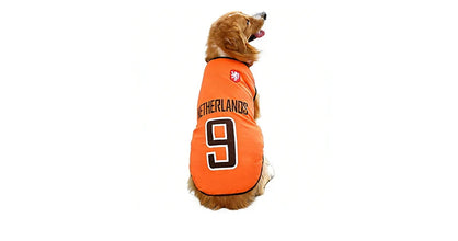 Golden Retriever wearing an orange Netherlands 9 football-style dog shirt with black trim