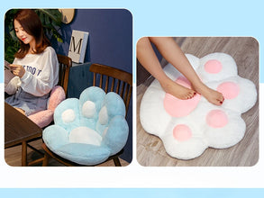 Plush paw-shaped chair cushion shown on a dining chair and used as a soft floor cushion