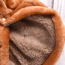 Close-up of soft brown fleece dog hoodie fabric