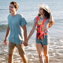 couple on beach using pet carrier with cat