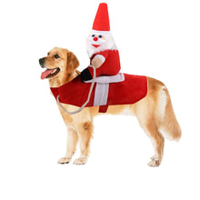 Dog wearing red Santa riding pet costume