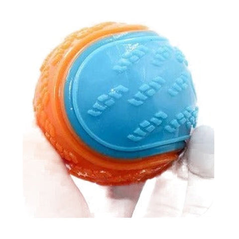 Blue and orange textured dog ball held in a gloved hand