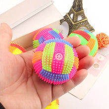 hand holding a glowing bouncy ball toy