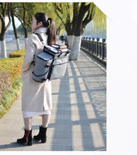 a girl standing wearing a backpack
