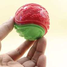 hand holding a squeaky dog ball toy