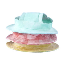 Stacked mint, pink and yellow dog caps with ear holes