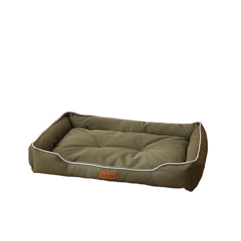 green pet bed on a cosy home background