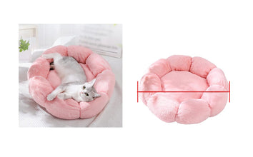 Grey and white cat relaxing in a pink flower-shaped plush cat bed with padded petal sides and a soft cushioned centre