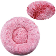 Pink fluffy donut dog bed with a soft faux fur surface, raised outer edge and close-up detail of the plush fibres