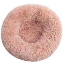 Pink round fluffy donut dog bed with a soft plush surface, raised outer edge and cushioned centre