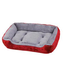 Red and grey plush dog bed with raised cushioned sides, a soft padded base and textured outer fabric