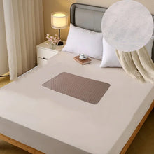 Small brown quilted waterproof bed protector pad with rounded edges placed on a mattress
