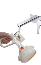 Portable dog poop scooper being rinsed under running water, showing its washable easy-clean design